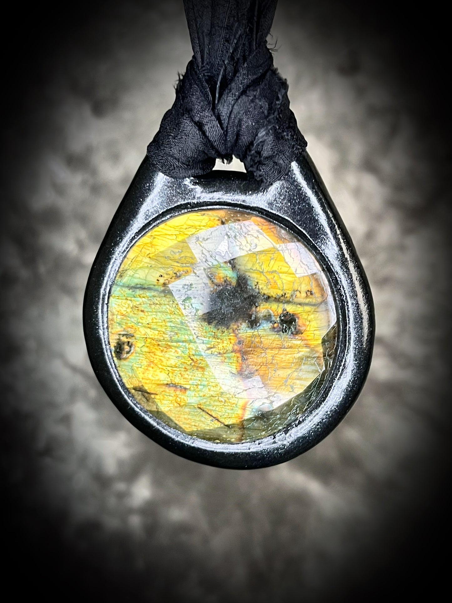 Witchy labradorite necklace on black recycled silk ribbon, hand-sculpted crystal talisman with iridescent gemstone pendant, boho gothic jewelry for modern witches.