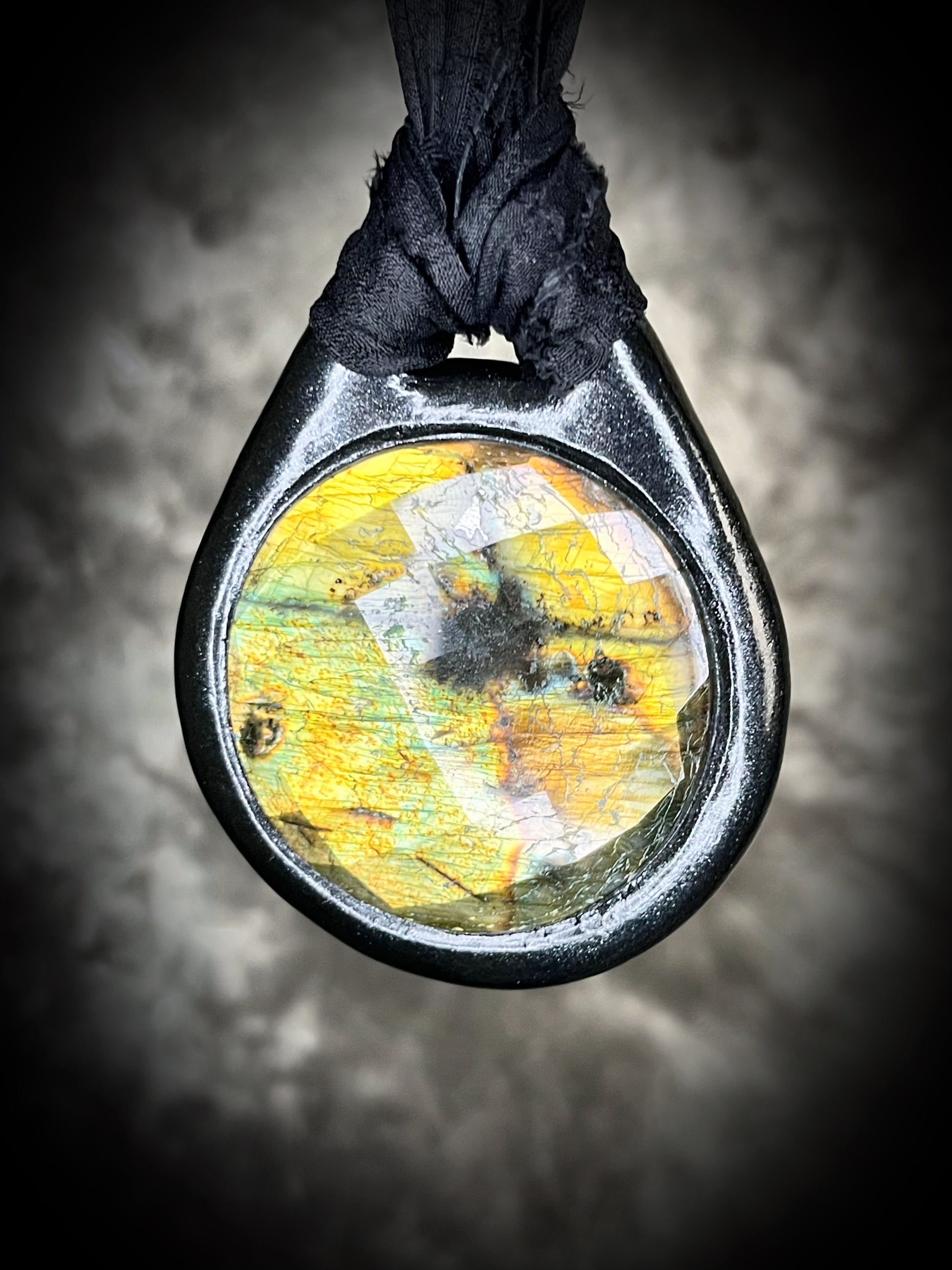 Witchy labradorite necklace on black recycled silk ribbon, hand-sculpted crystal talisman with iridescent gemstone pendant, boho gothic jewelry for modern witches.