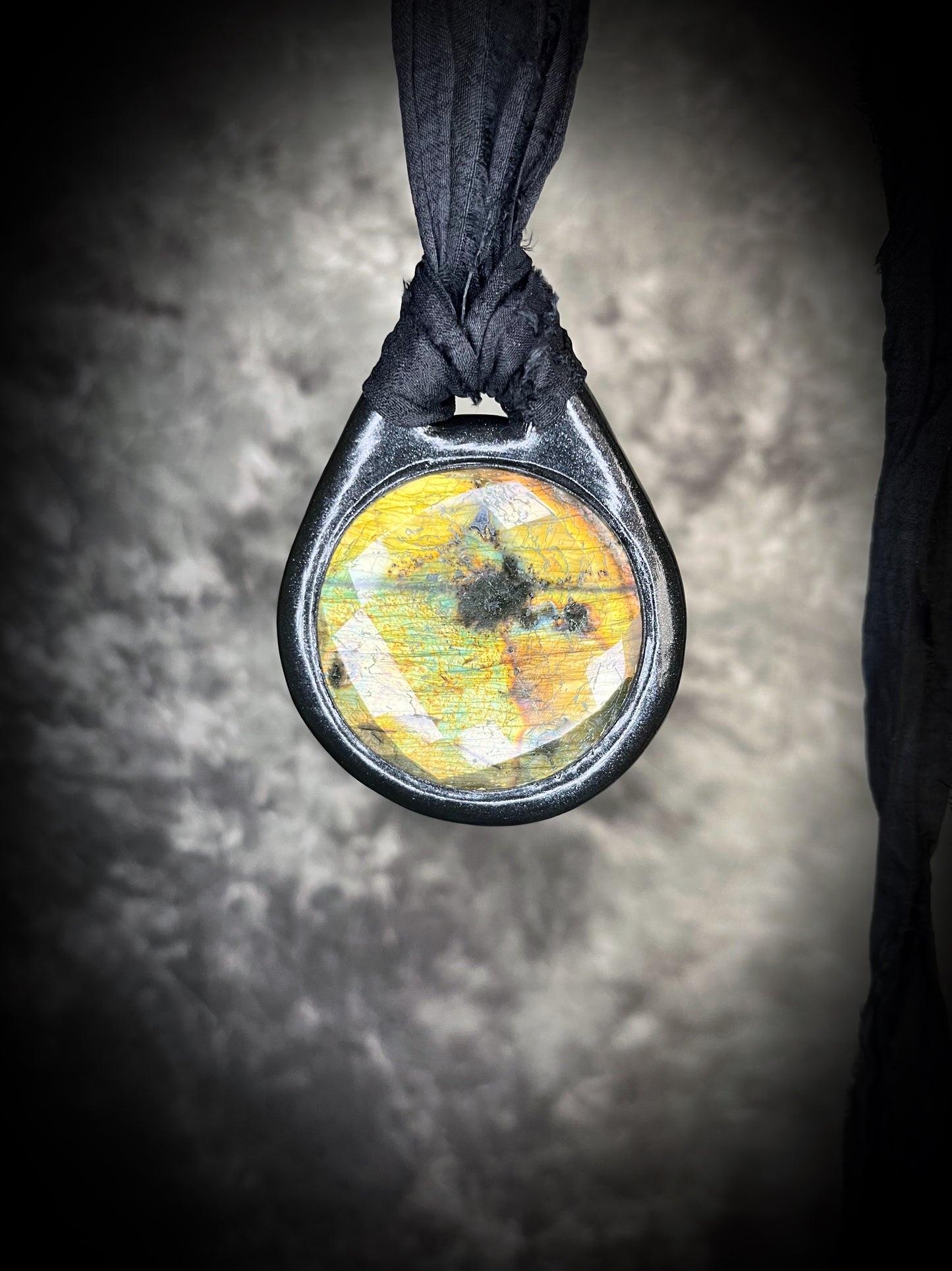 Witchy labradorite necklace on black recycled silk ribbon, hand-sculpted crystal talisman with iridescent gemstone pendant, boho gothic jewelry for modern witches.