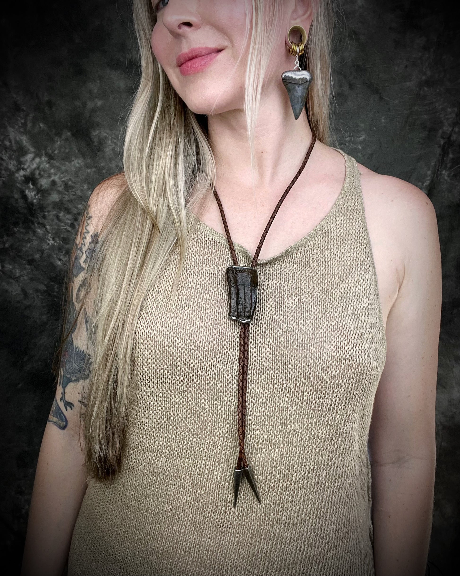 XL mako shark tooth fossil earrings in silver finish with sterling-plated huggie hooks, ocean-inspired statement fossil jewelry handmade in Baltimore Maryland. Worn here with Equus horse tooth fossil bolo tie. 