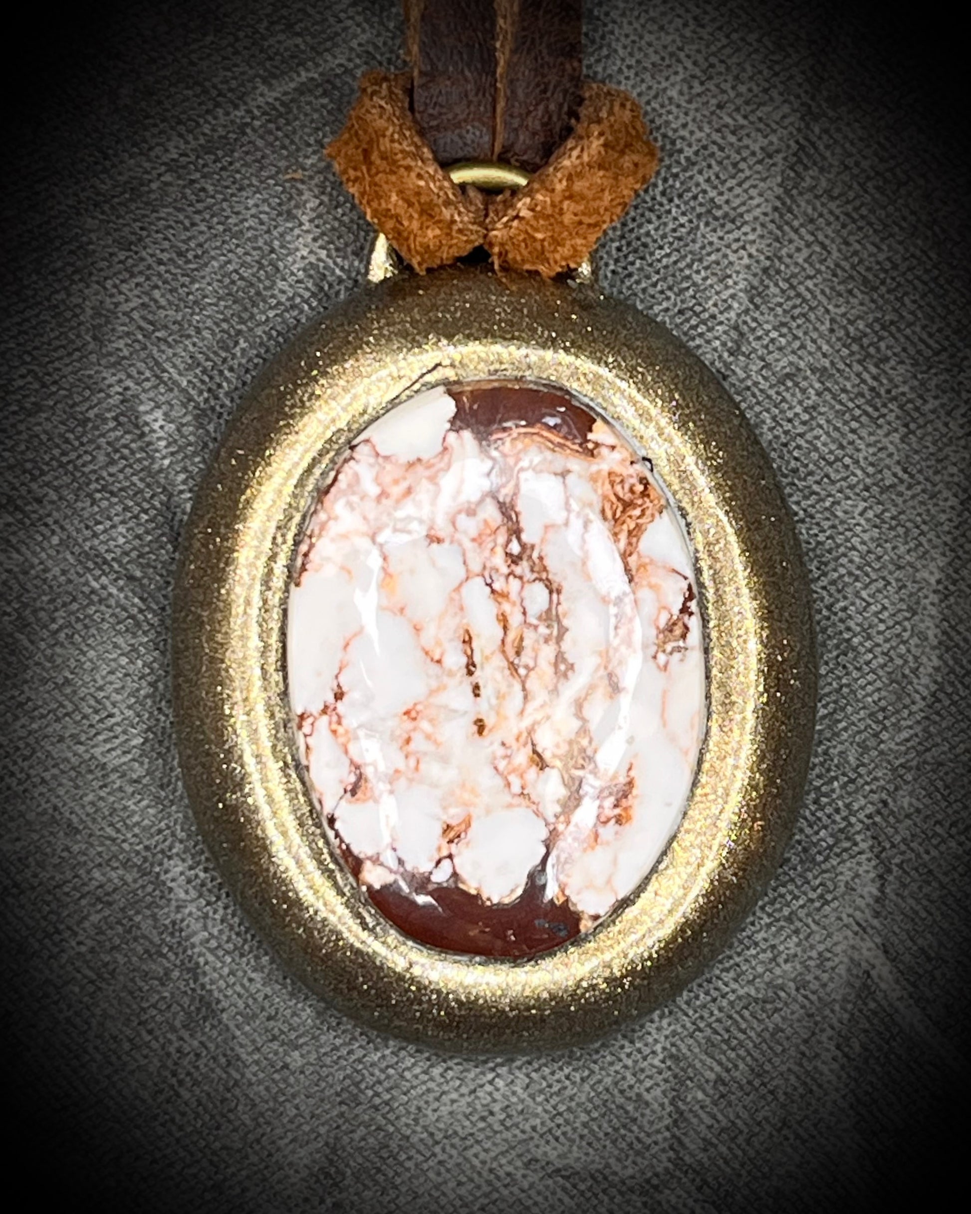 Year of the Horse inspired necklace featuring Wild Horse Magnesite crystal, in a gold setting and hung from earthy brown leather. Talisman for wild hearts and boho western fashion. 