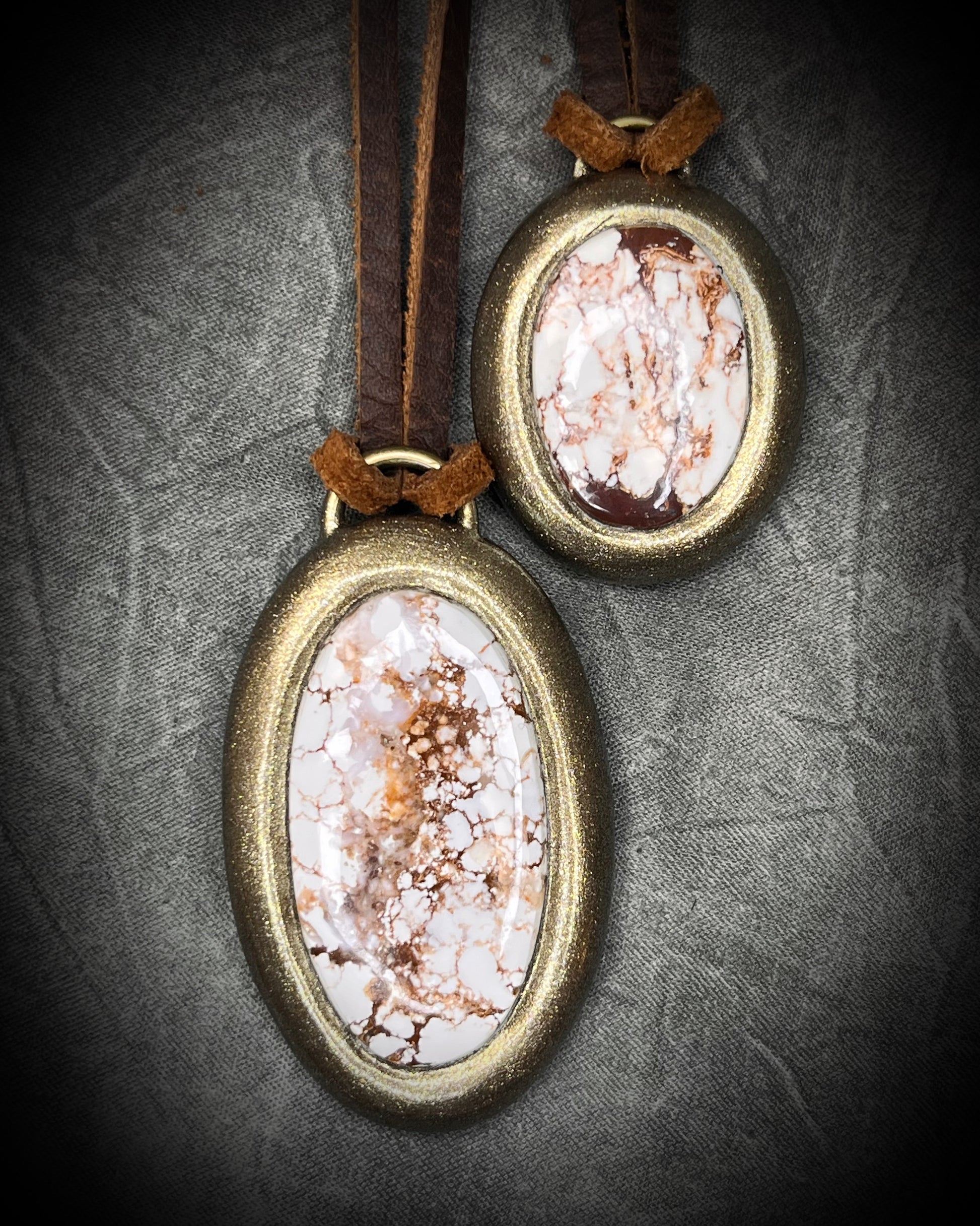 Year of the Horse inspired necklaces featuring Wild Horse Magnesite crystal, both in a gold setting and hung from earthy brown leather. Talismans for wild hearts and boho western fashion. 