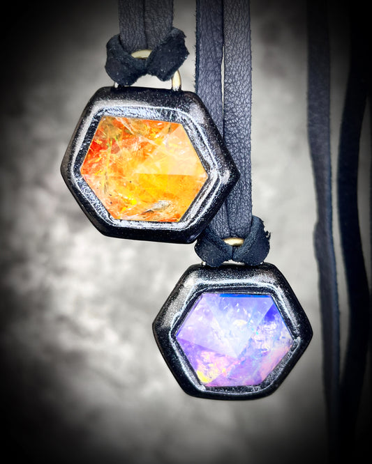 Amethyst and fire citrine hexagon crystal talismans on black leather — handmade mystical jewelry collection with black metal finish