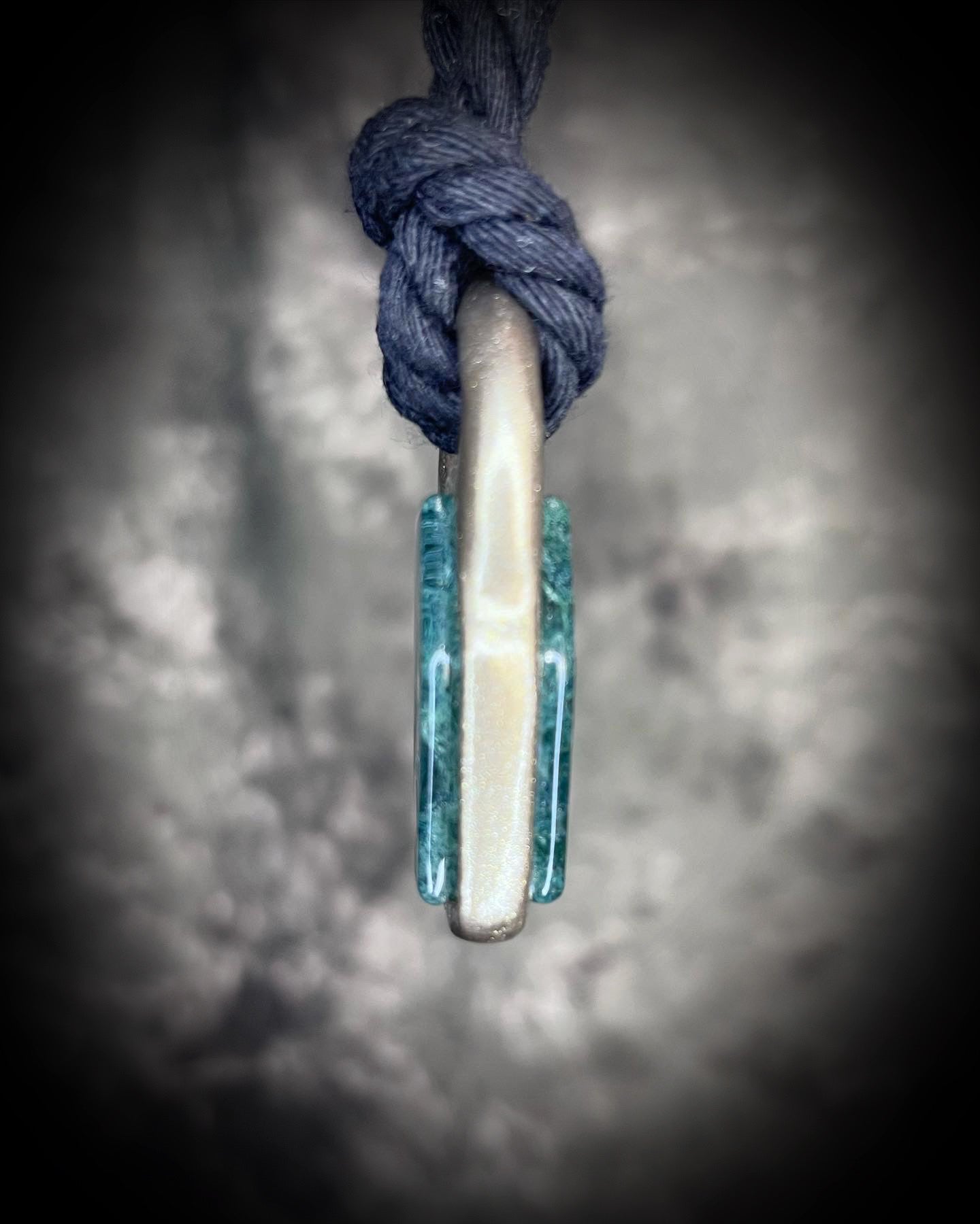 Moss agate coffin shaped necklace in a gold finish on a black cotton cord.  Coffin crystal pendant fall 2025 gift for her.