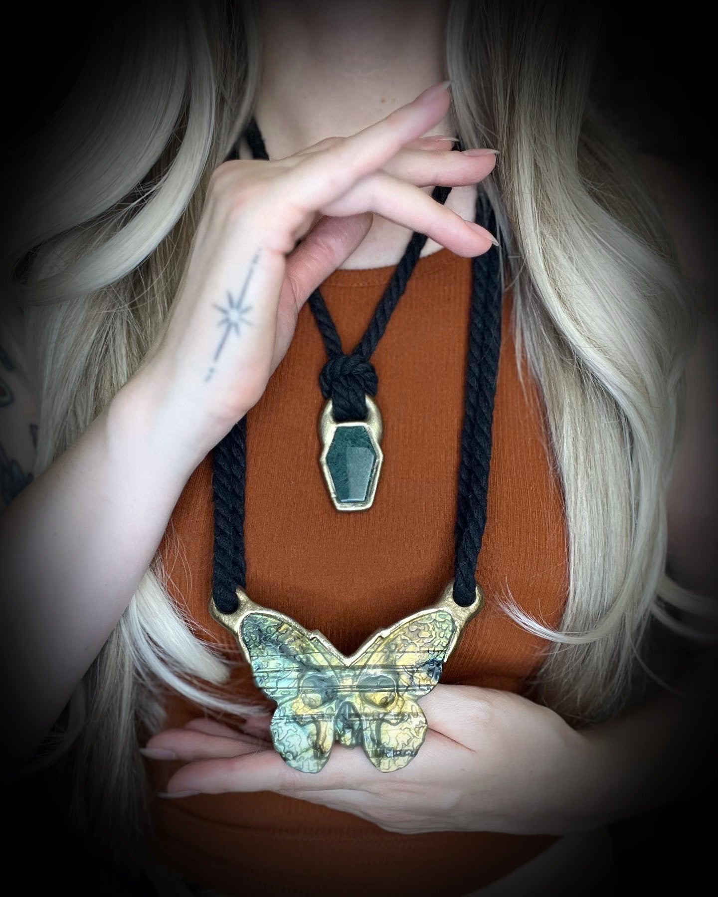 Moss agate coffin shaped necklace in a gold finish on a black cotton cord.  Coffin crystal pendant fall 2025 gift for her.