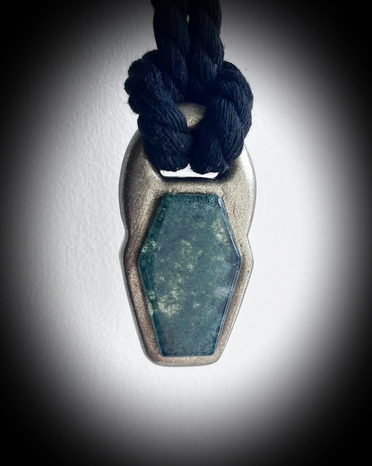 Moss agate coffin shaped necklace in a gold finish on a black cotton cord.  Coffin crystal pendant fall 2025 gift for her.