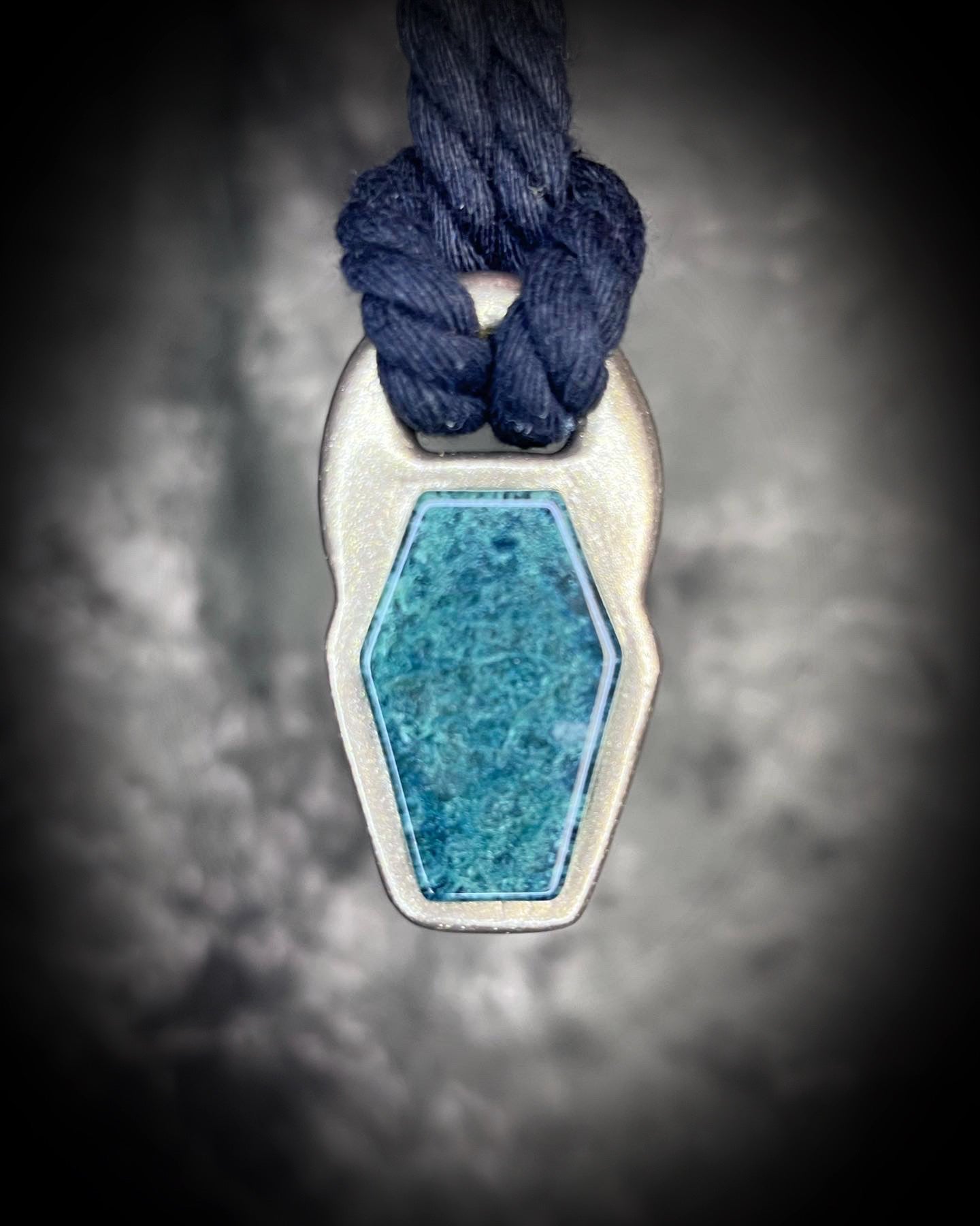 Moss agate coffin shaped necklace in a gold finish on a black cotton cord.  Coffin crystal pendant fall 2025 gift for her.