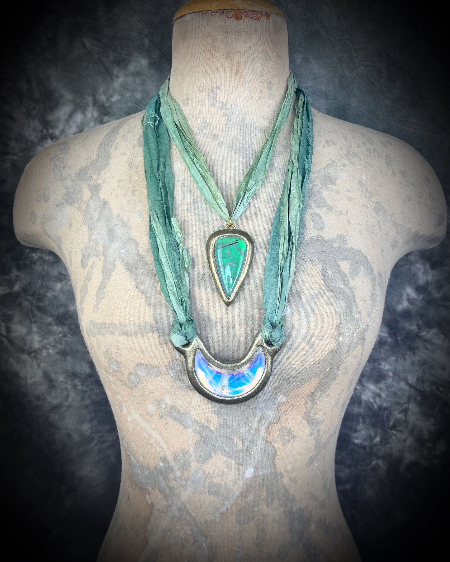 Handmade designer opalescent quartz gemstone crescent moon pendant in a gold finish.  This crystal healing necklace is strung from mint green recycled silk for the eco-friendly jewelry collector.  