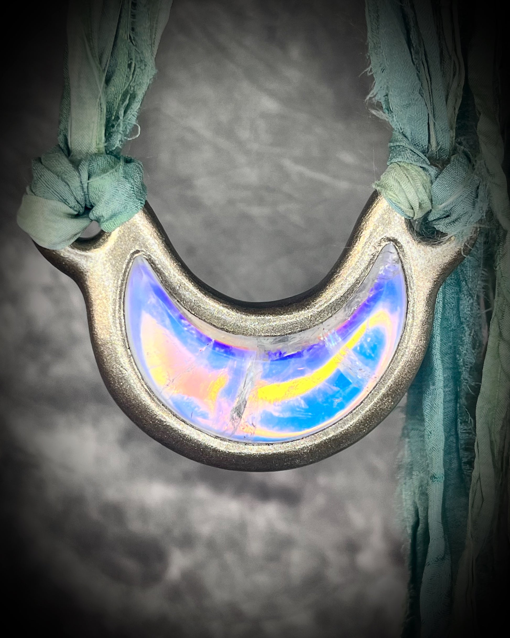 Handmade designer opalescent quartz gemstone crescent moon pendant in a gold finish.  This crystal healing necklace is strung from mint green recycled silk for the eco-friendly jewelry collector.  