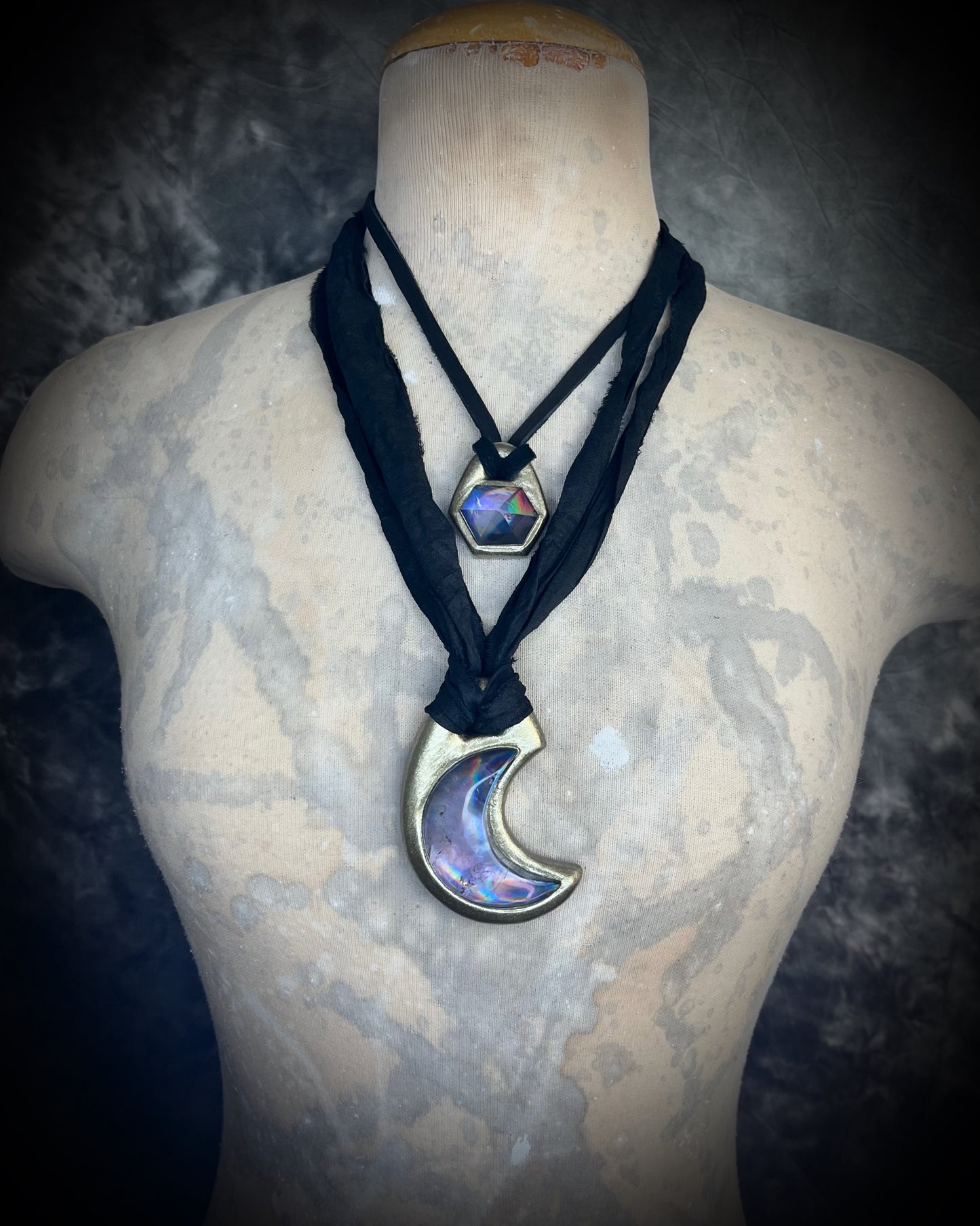 Metallic gold crescent moon pendant with iridescent rainbow quartz crystal on black recycled silk