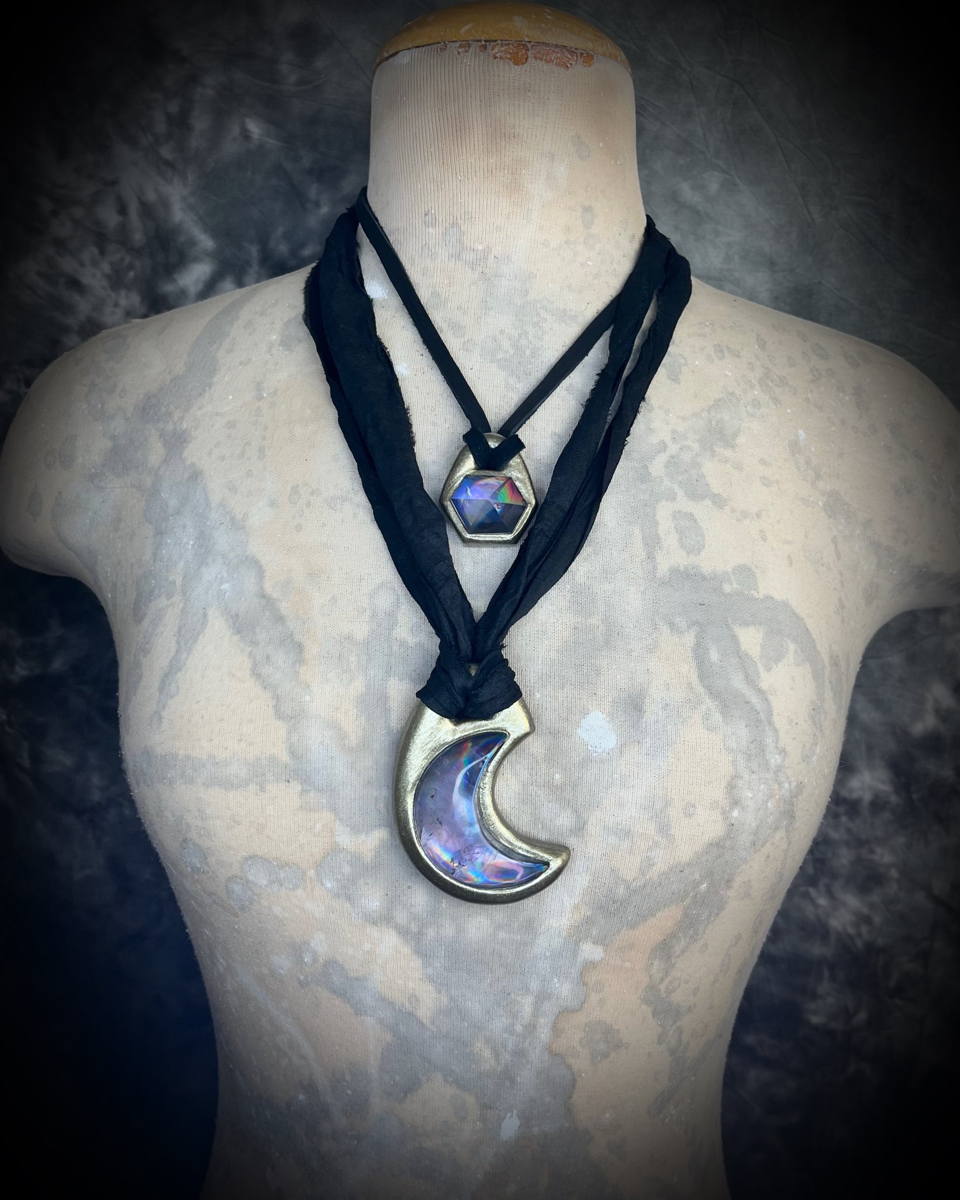 Metallic gold crescent moon pendant with iridescent rainbow quartz crystal on black recycled silk