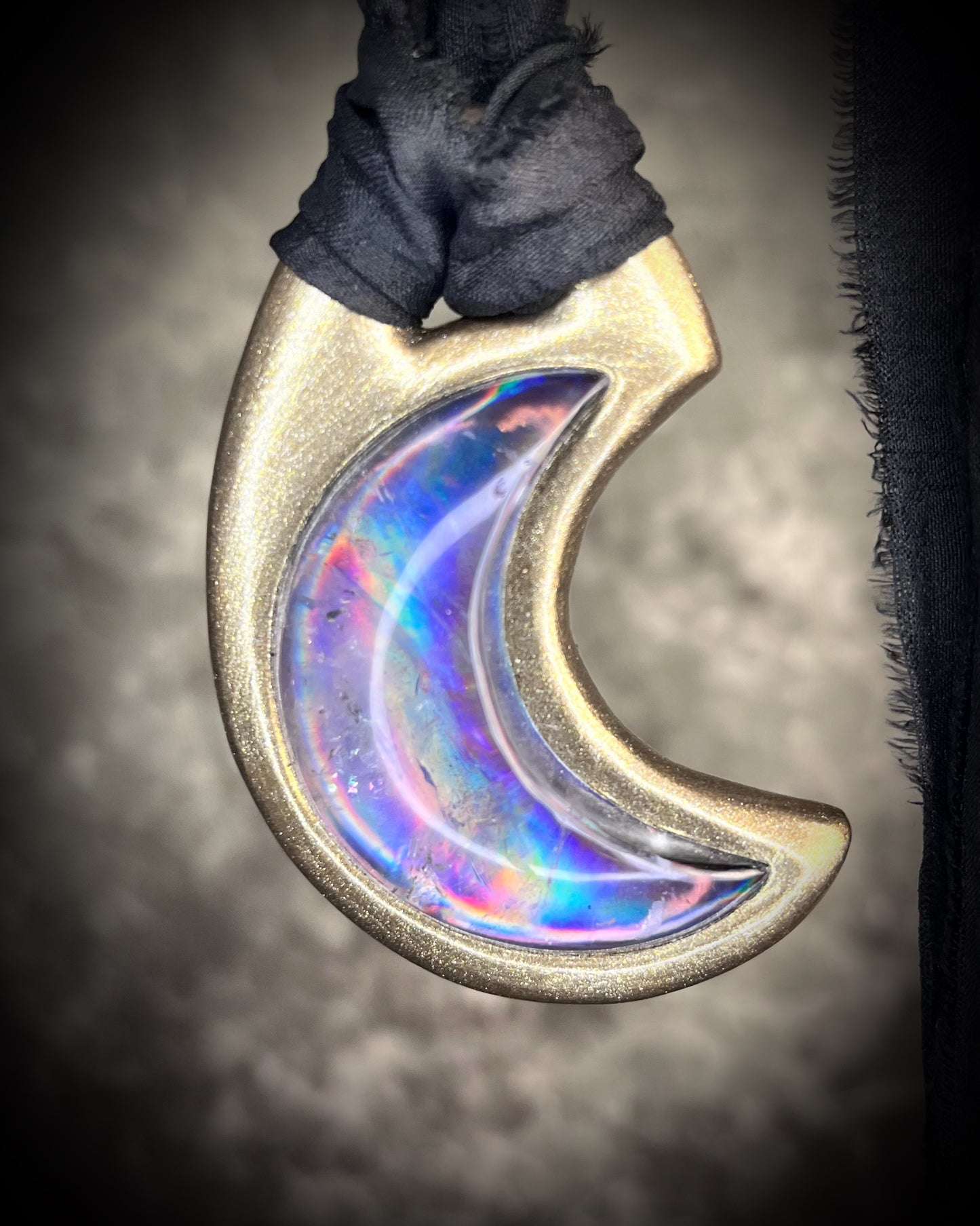 Metallic gold crescent moon pendant with iridescent rainbow quartz crystal on black recycled silk