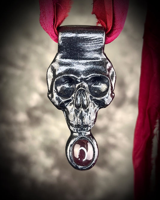 Handmade sculptural skull and natural garnet crystal talisman.  Pendant gift for her, hung from red recycled silk for a gothic elegance. 