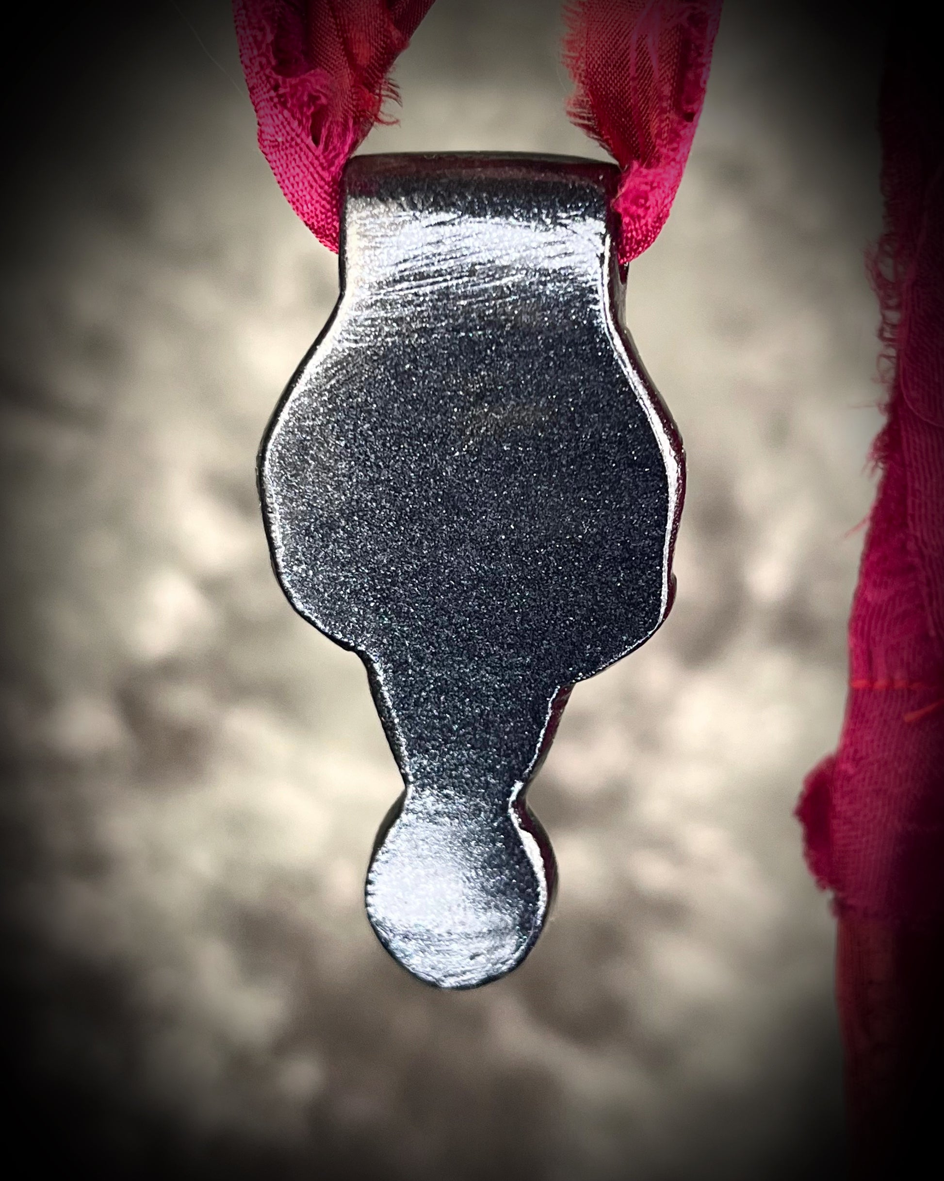 Handmade sculptural skull and natural garnet crystal talisman.  Pendant gift for her, hung from red recycled silk for a gothic elegance. 