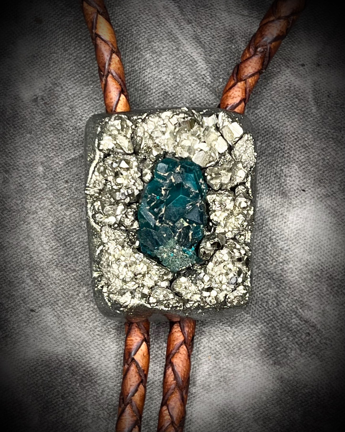 Pyrite and dioptase mosaic crystal bolo tie on brown leather – unique handmade gemstone bolo necklace, artisan gemstone bolo tie jewelry, mystical men’s bolo for bold style.
