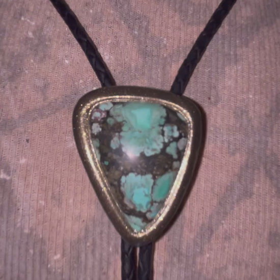 Turquoise handmade bolo tie for him with gold finish on black leather. Boho western bolo tie necklace for spiritual rebels.