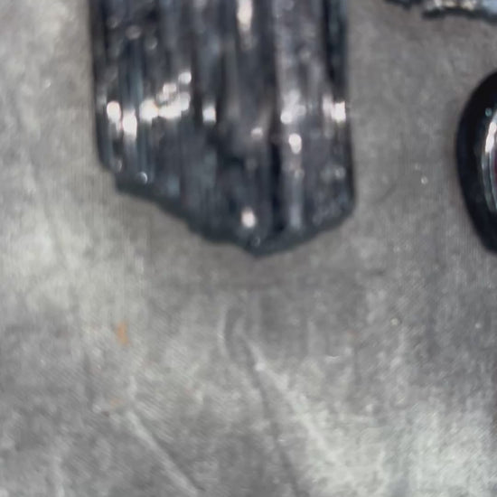 Skull-shaped pendant with a yellow fire citrine teardrop shaped gemstone on a dark background. Halloween jewelry for her, gothic jewelry gift for her. 