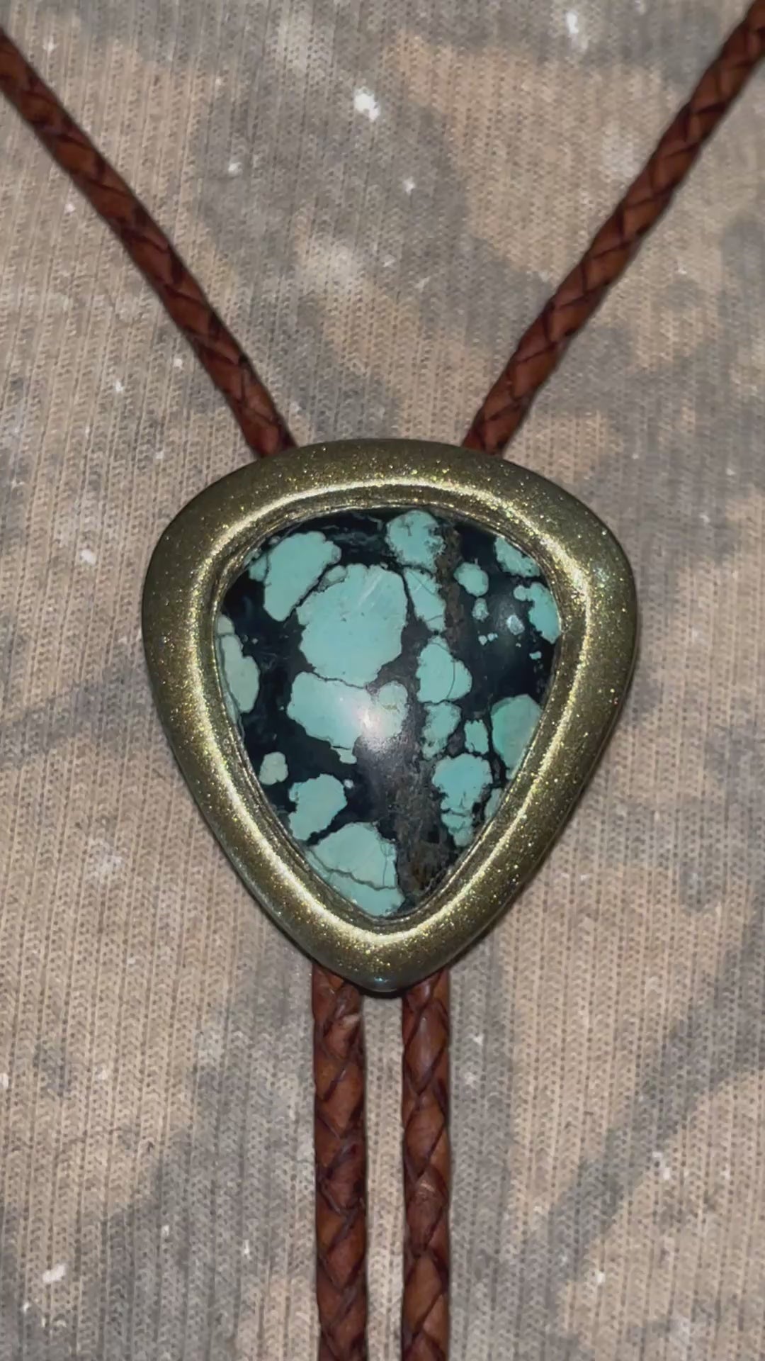 Mystical western wear turquoise bolo tie gift for him or her. Gold and brown leather with teal and black natural gemstone. 