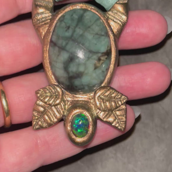 Emerald and black opal gemstone necklace in a luxe gold setting, crafted on aqua recycled silk. One-of-a-kind crystal healing pendant, sustainable and perfect for 2025 gifting. 