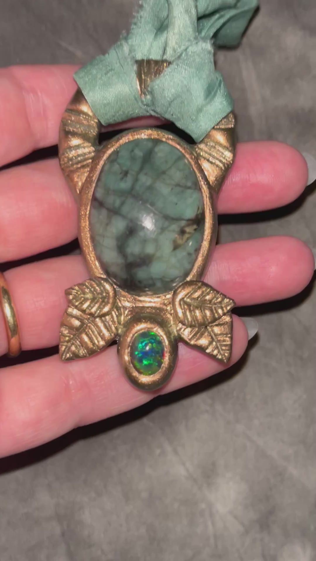 Emerald and black opal gemstone necklace in a luxe gold setting, crafted on aqua recycled silk. One-of-a-kind crystal healing pendant, sustainable and perfect for 2025 gifting. 