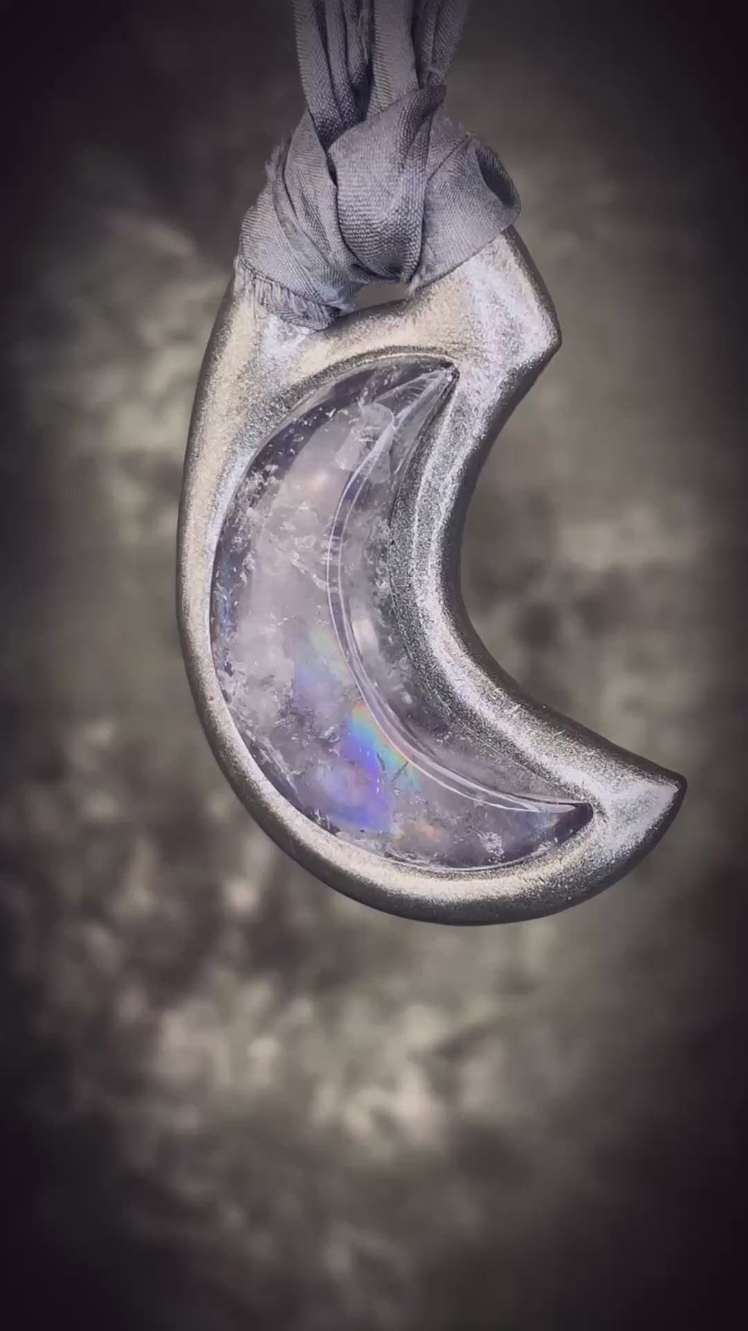Black rainbow quartz crescent moon talisman on recycled silk with dark iridescent rainbow flashes, handcrafted by Become Spellbound.
