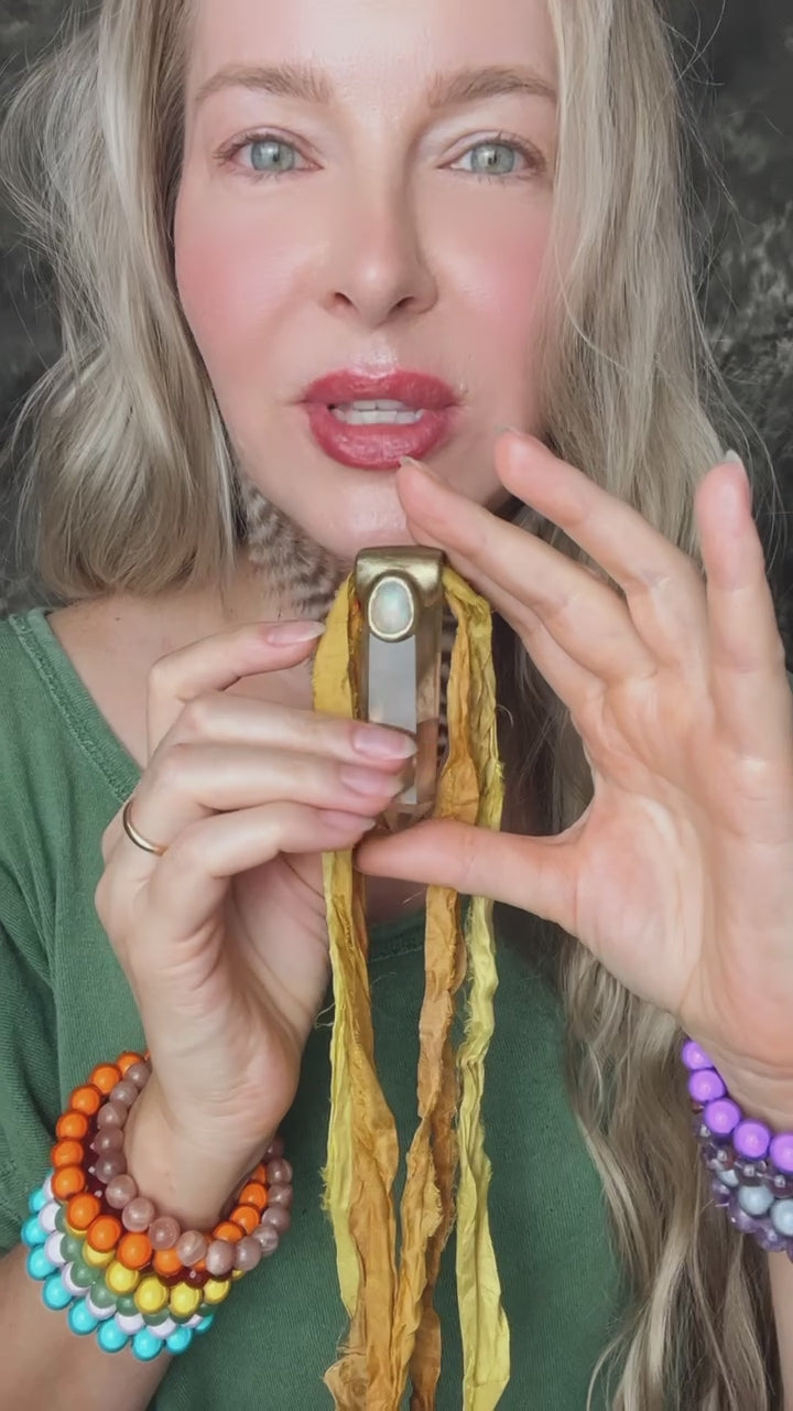 Video showing citrine and opal gemstone necklace on yellow recycled silks, sustainable festival jewelry, summer, eco-friendly handmade jewelry