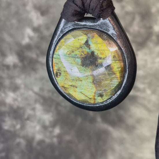 Witchy labradorite necklace on black recycled silk ribbon, hand-sculpted crystal talisman with iridescent gemstone pendant, boho gothic jewelry for modern witches.
