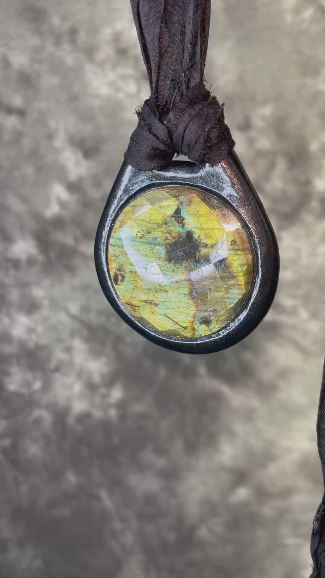 Witchy labradorite necklace on black recycled silk ribbon, hand-sculpted crystal talisman with iridescent gemstone pendant, boho gothic jewelry for modern witches.