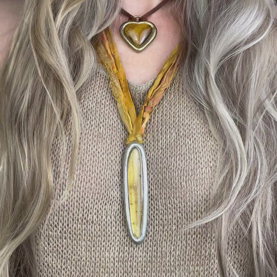  Video of ancient insect included amber pendant in silver finish on marigold and yellow recycled silks. Enchanting natural history holiday gift for her! 