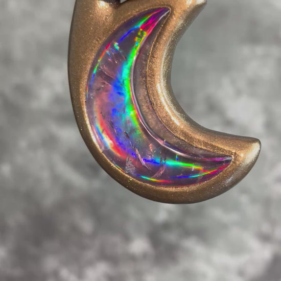 Metallic gold crescent moon pendant with iridescent rainbow quartz crystal on black recycled silk