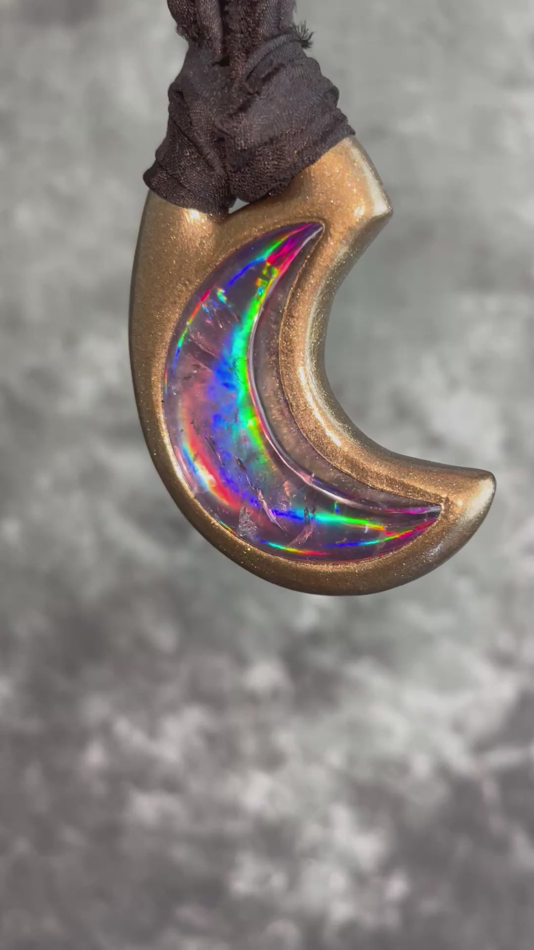 Metallic gold crescent moon pendant with iridescent rainbow quartz crystal on black recycled silk