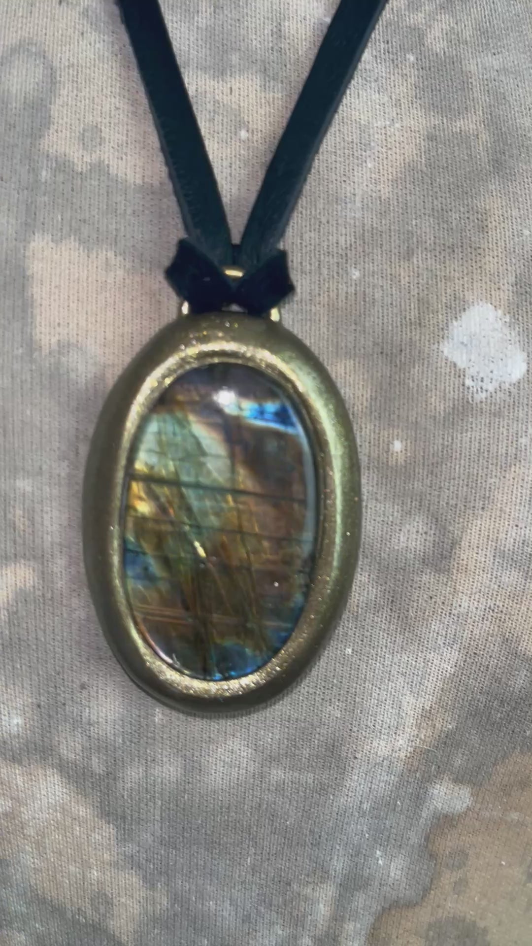 Mystical labradorite necklace on black leather cord, hand-sculpted artisan talisman with raw gemstone pendant, gothic crystal jewelry for spiritual style.