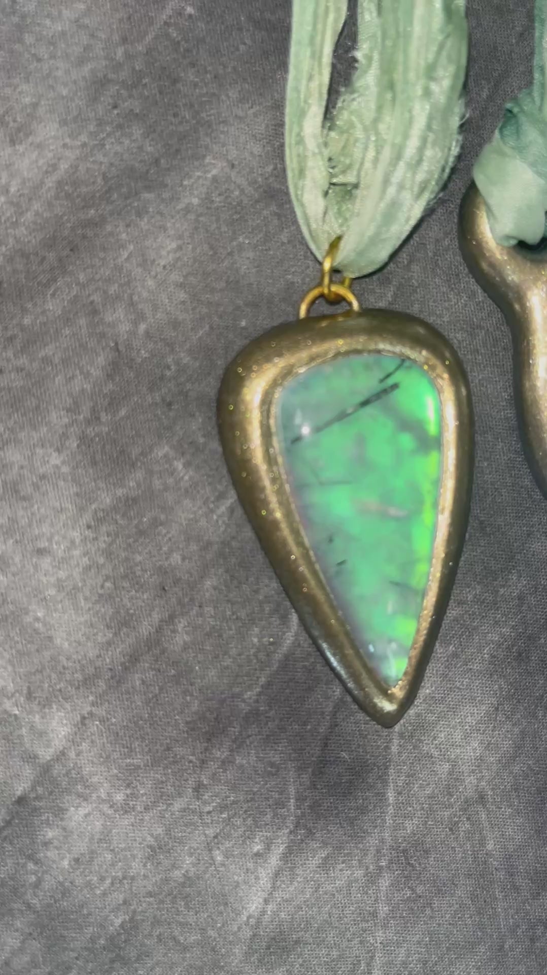 Handmade designer opalescent quartz gemstone crescent moon pendant in a gold finish.  This crystal healing necklace is strung from mint green recycled silk for the eco-friendly jewelry collector.  