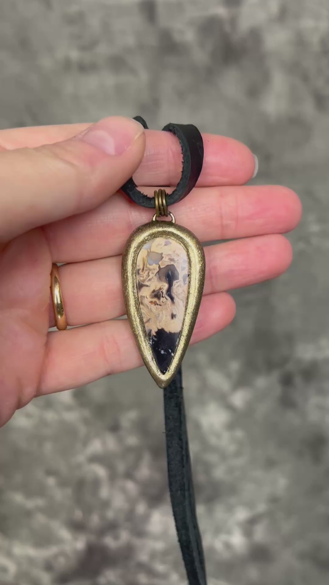 Petrified palm root necklace, teardrop shaped and set in a gold finish. Fossilized wood pendant hung from black leather for a protective and grounding vibe. 