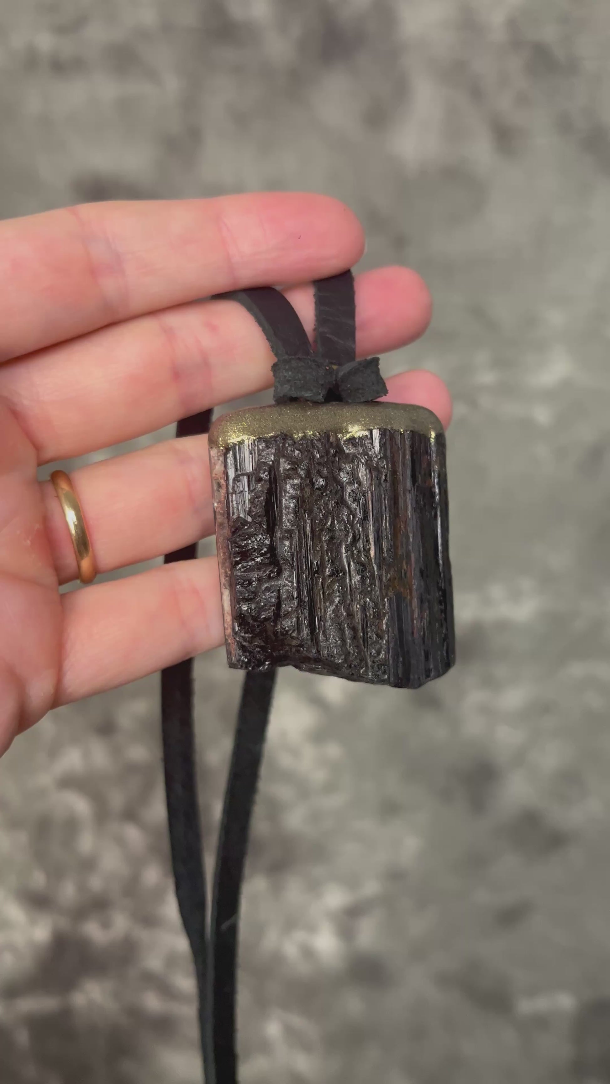 Gold finish, square shaped raw stone Black tourmaline grounding and protection pendant hung from black leather for an earthy adornment. Open back to touch skin and ground you. 