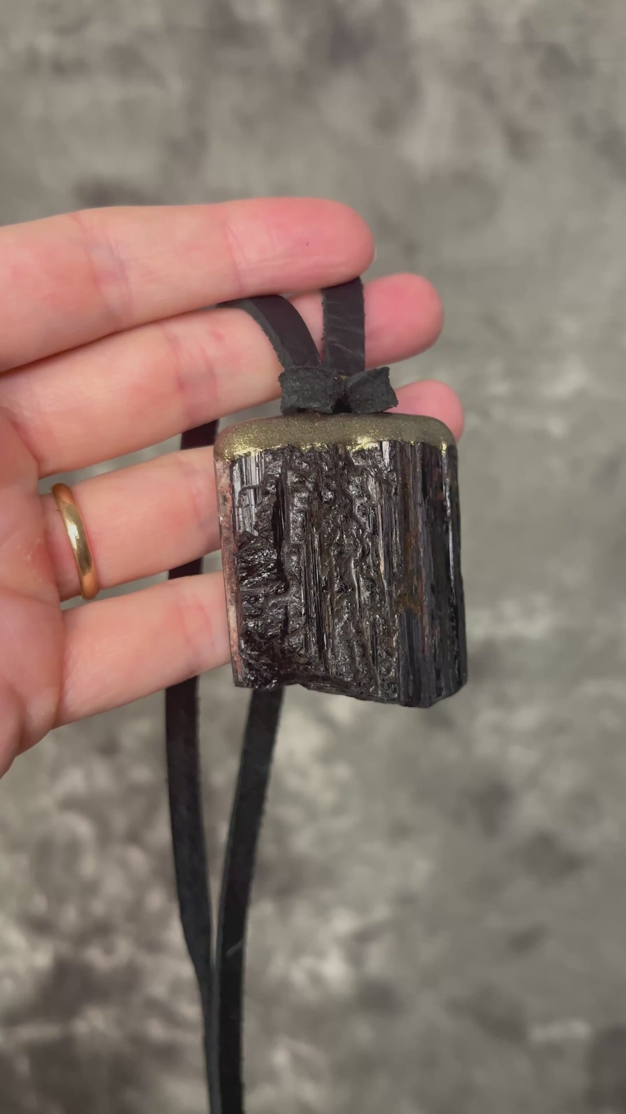 Gold finish, square shaped raw stone Black tourmaline grounding and protection pendant hung from black leather for an earthy adornment. Open back to touch skin and ground you. 