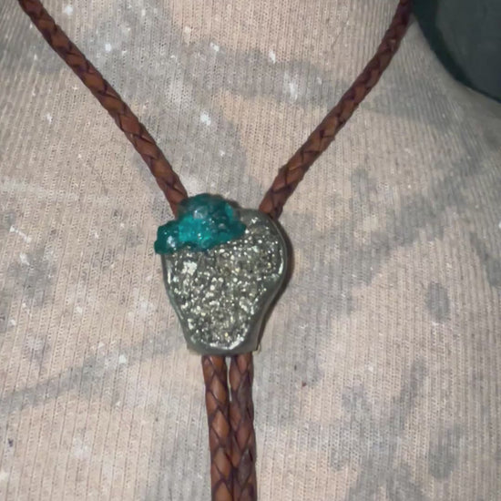 Video of Chunky Pyrite and Dioptase crystal bolo tie on brown leather – unique handmade bolo necklace, artisan gemstone bolo tie jewelry, mystical men’s bolo for bold style.