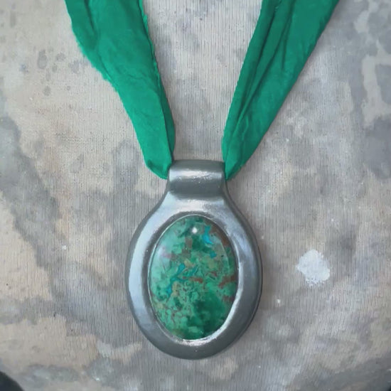 Oval Chrysocolla gemstone pendant in silver finish on emerald green recycled silk cord.