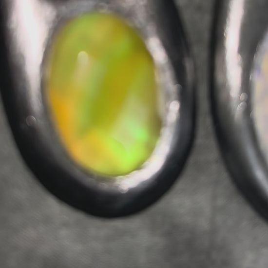 Handcrafted designer opalescent quartz gemstone crescent moon pendant in a silver finish with sustainable festival style recycled silks. 