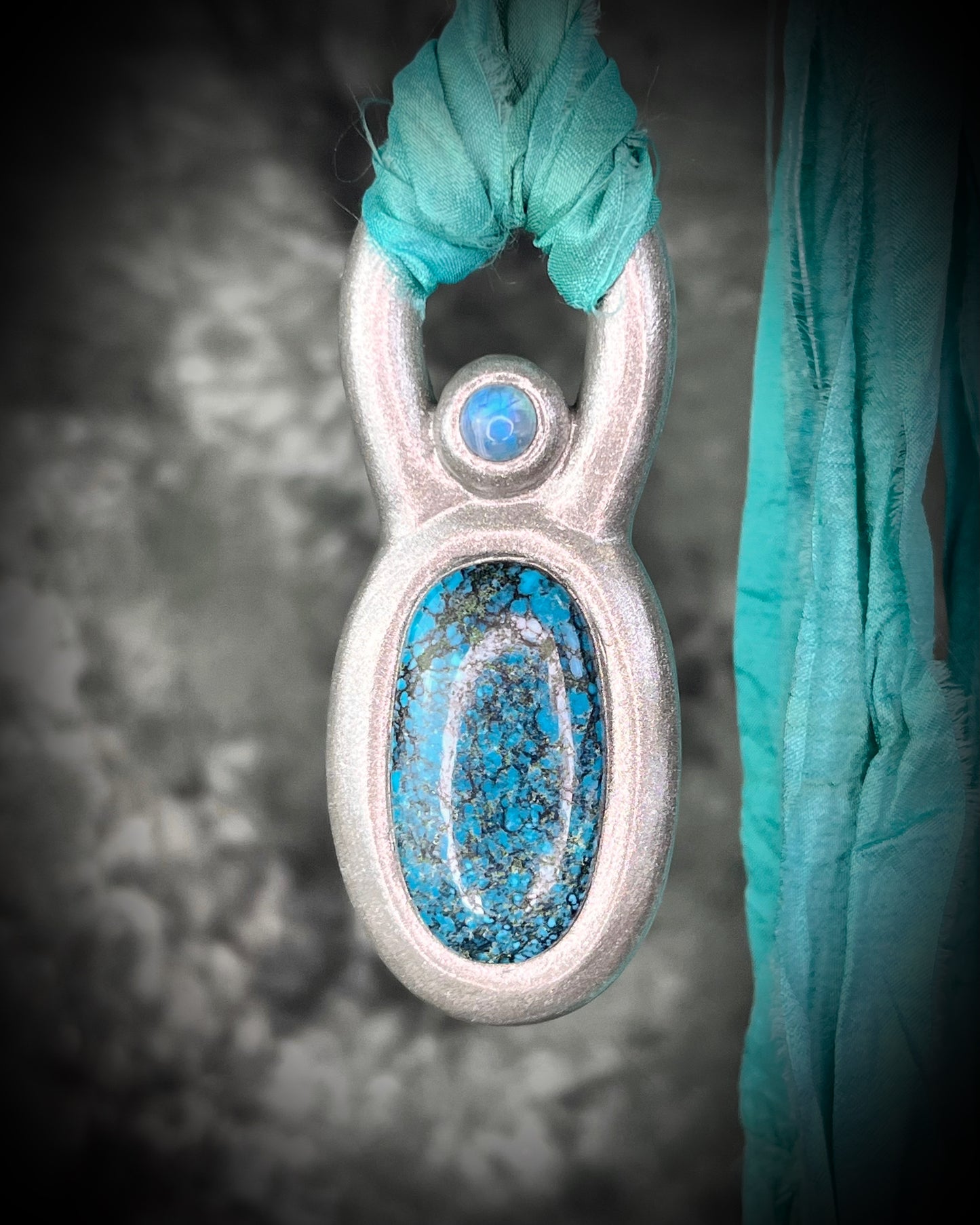 Handmade statement maximalist Turquoise and Moonstone chunky silver crystal jewelry on aqua recycled silk for a western  jewelry appeal.