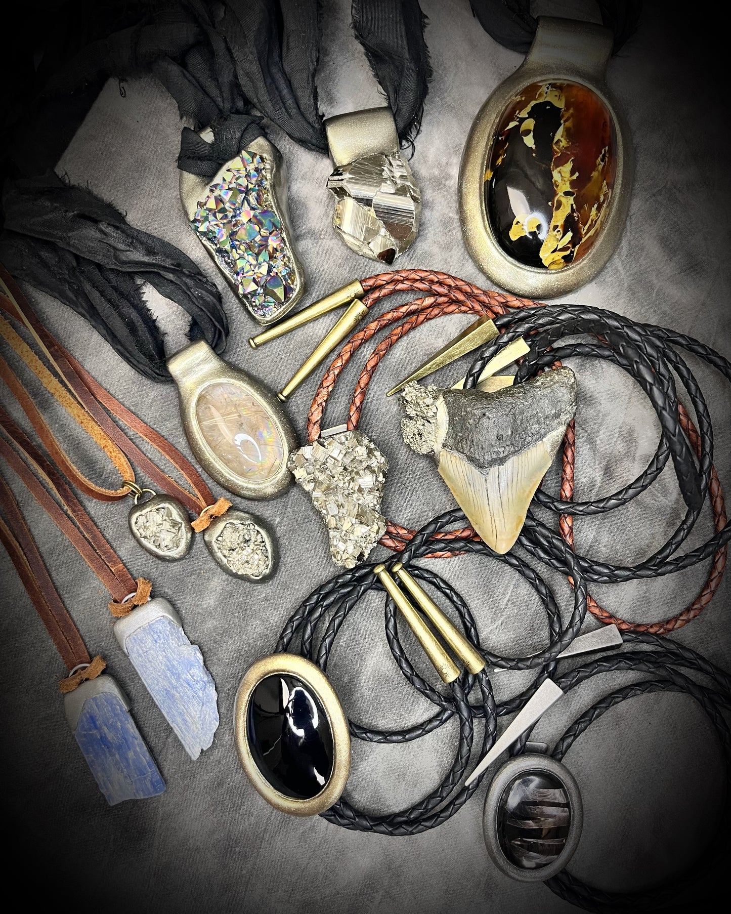 Collection of various necklaces with natural elements on a textured surface